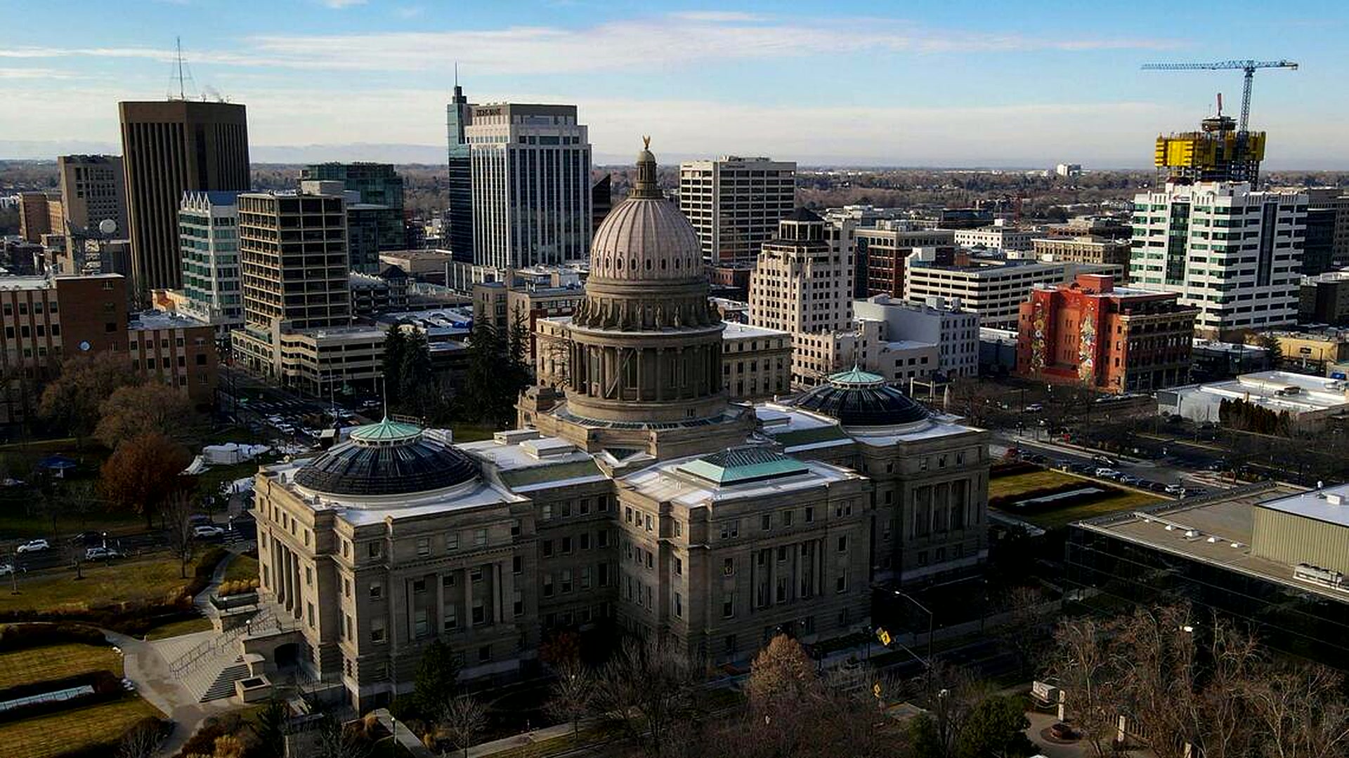 Aerial view of downtown Boise, Idaho with the foothills behind the city